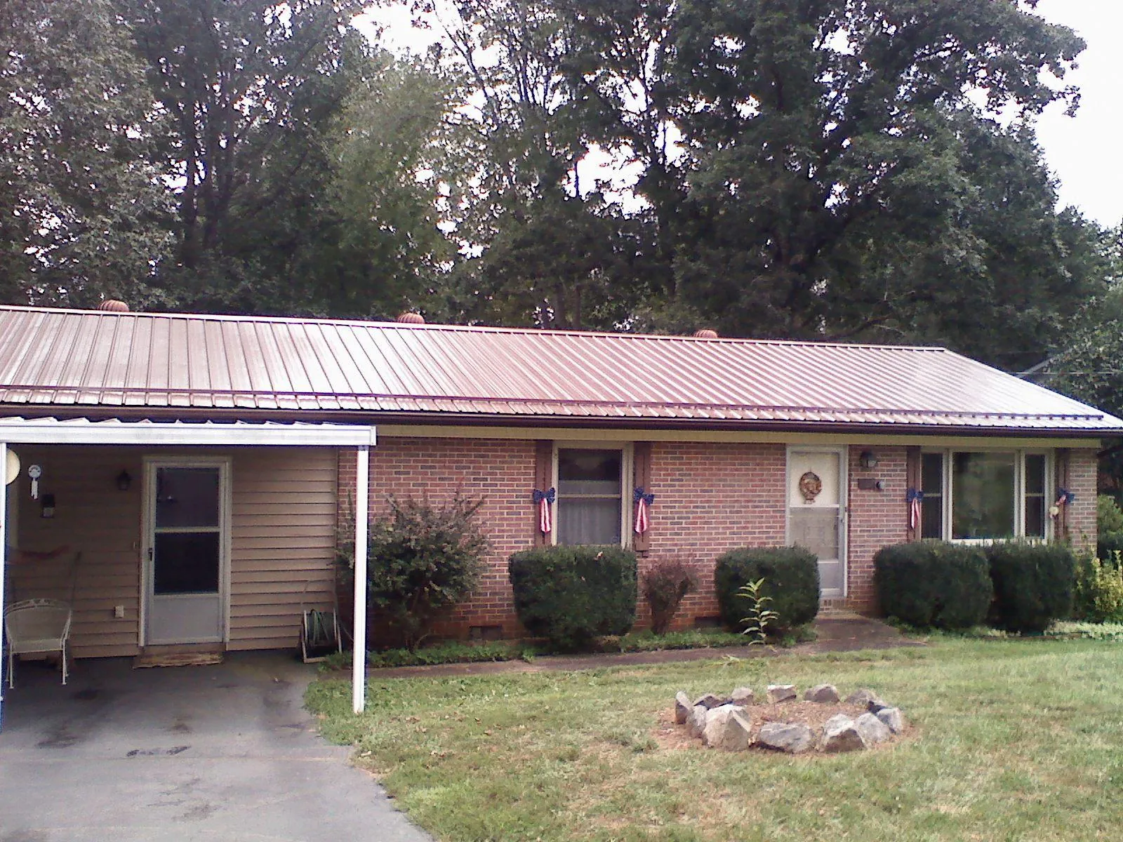 Bronze metal roof and carport on a brick ranch home — Roof Repair work by our crew in Port Royal